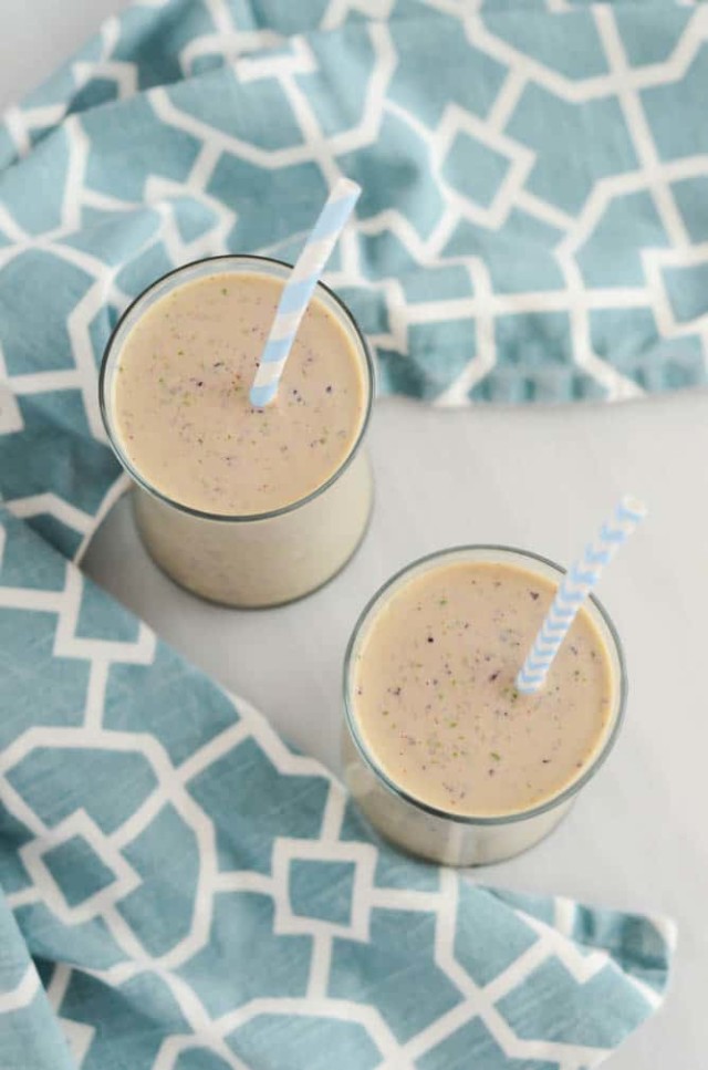An overhead shot of two glasses of Power Protein Smoothie with blue striped straws.