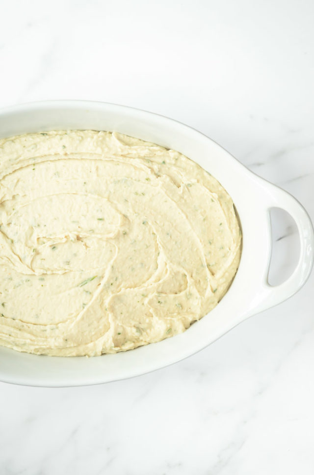 The first layer of Italian 5-Layer Dip is a creamy white bean spread.