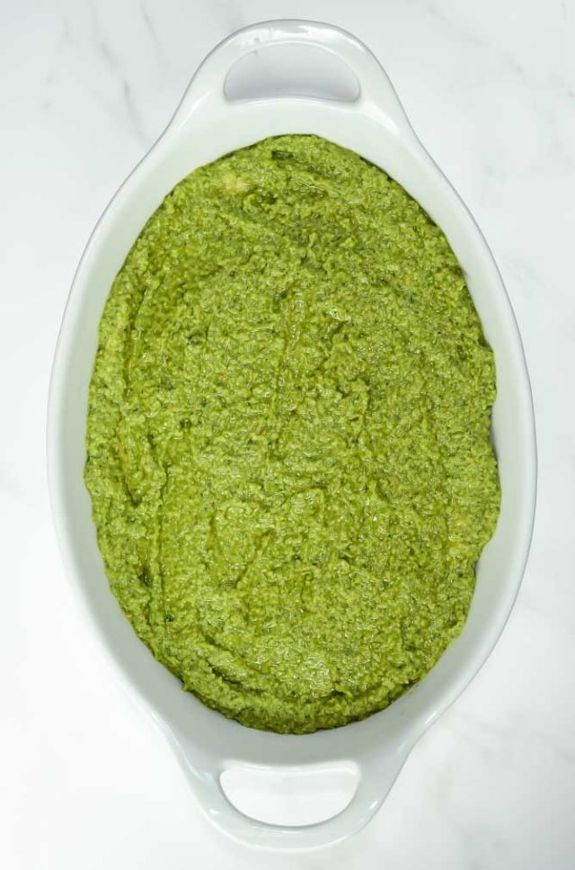 The second layer of Italian 5-Layer Dip is a homemade pesto.