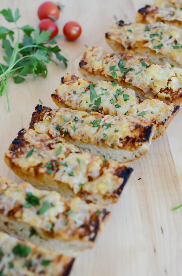 A close-up shot of gooey and delicious Cheesy BBQ Garlic Bread.