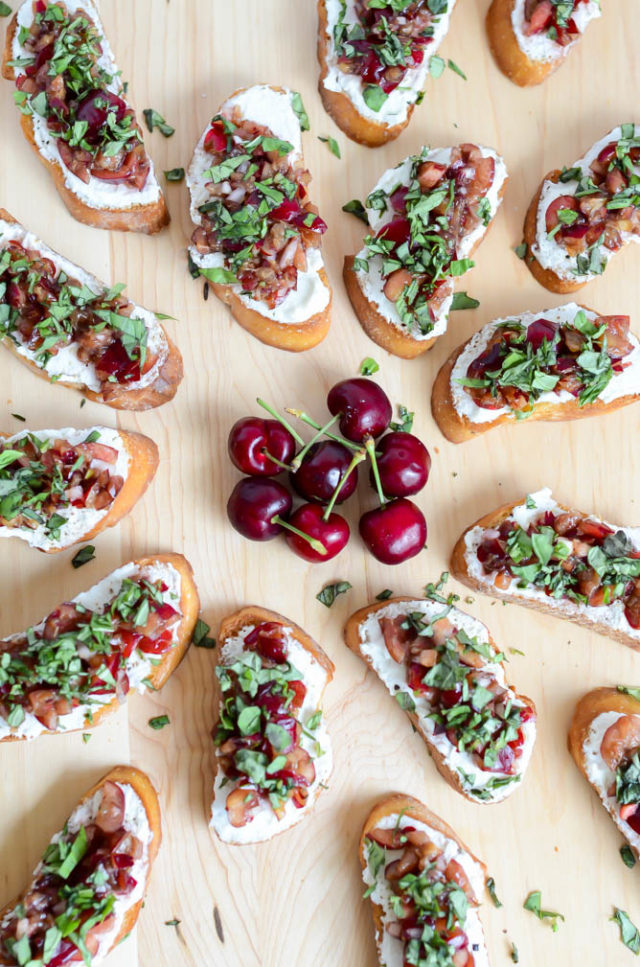 A beautiful display of Herbed Cherry and Ricotta Crostini, ready to be enjoyed by all of your dinner party guests!
