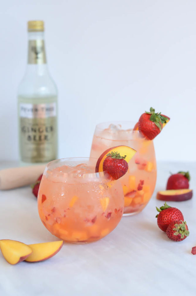 Two chilled glasses of a refreshing Ginger Strawberry Peach Smash from CaliGirlCooking.com.