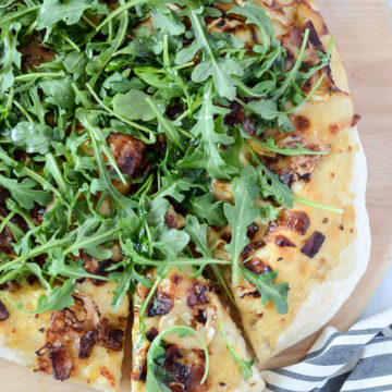 This Bacon and Goat Brie Pizza with Vanilla Passion Fruit Jam is delicious fresh out of the oven and topped with fresh arugula.