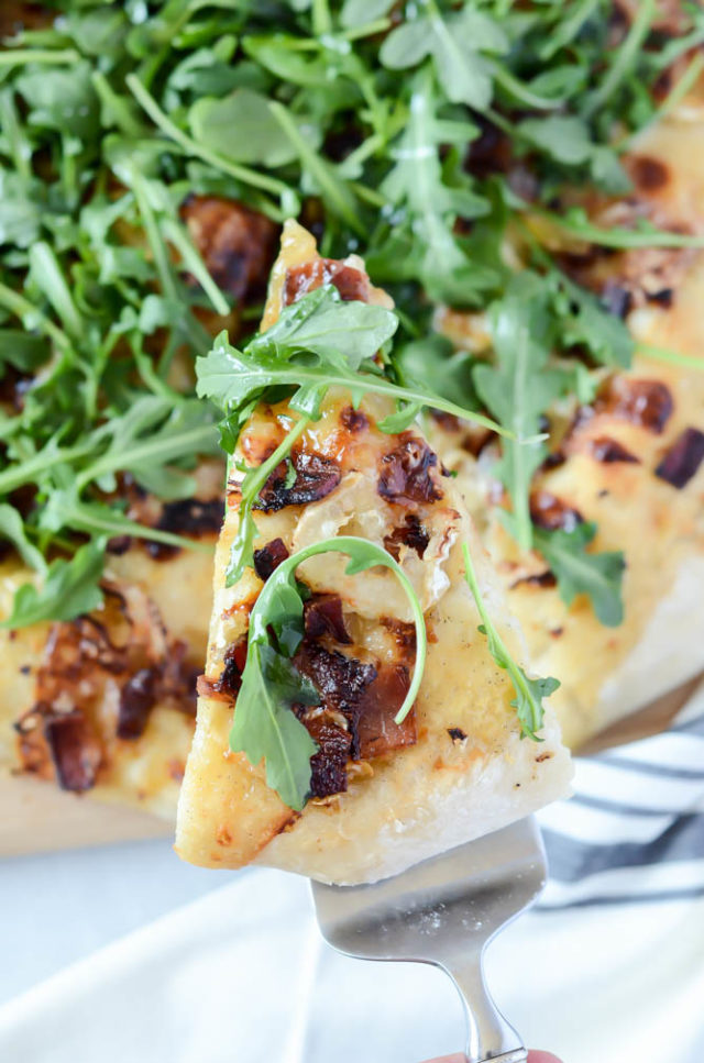 A delicious slice of Bacon and Goat Brie Pizza with Vanilla Passion Fruit Jam.