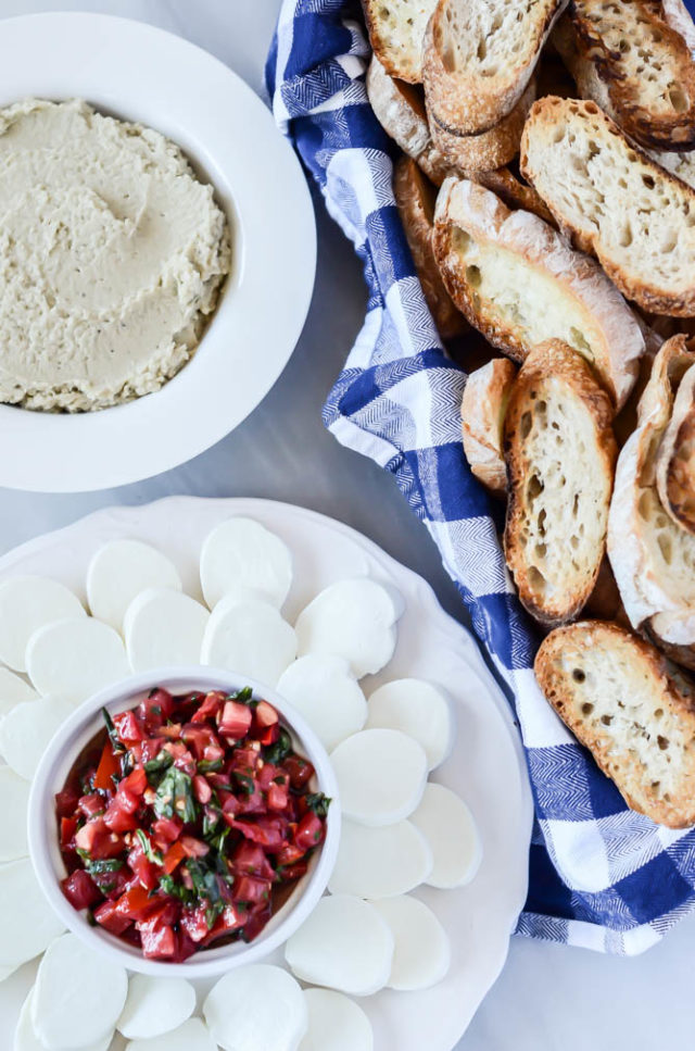 A Bruschetta Bar is an easy entertaining idea that will keep all guests happy, especially with a Classic Tomato Bruschetta with Mozzarella and Roasted Eggplant White Bean Spread!