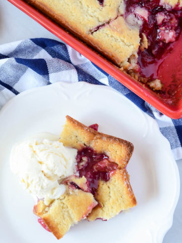 Hot Upside Down Pluot Cobbler fresh out of the oven and topped with a generous scoop of vanilla ice cream.