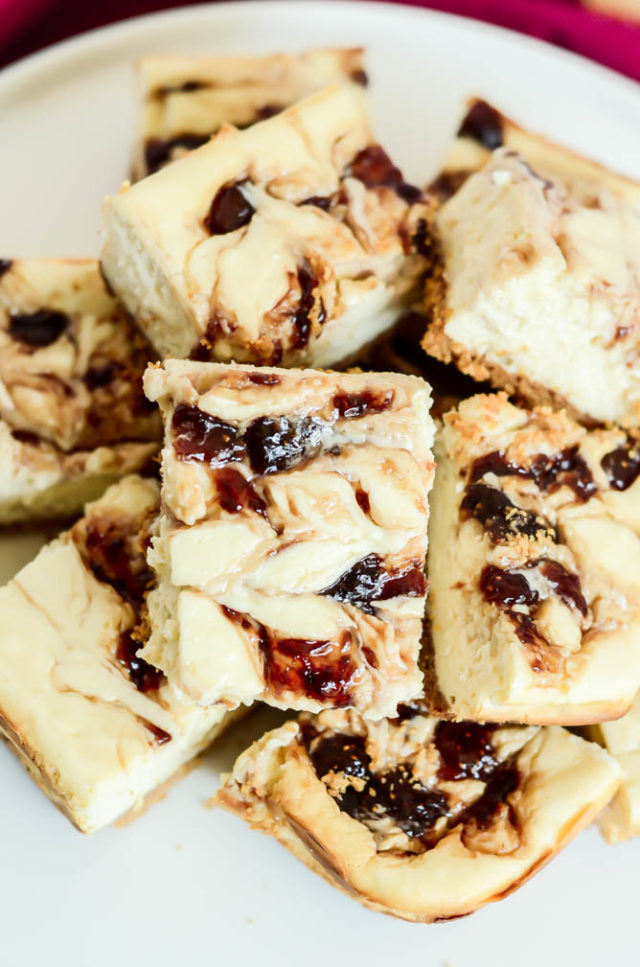 A close-up look at super-tasty Peanut Butter and Jelly Cheesecake Bars.