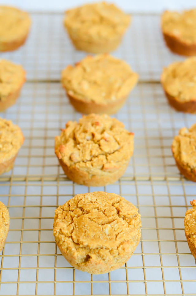 A cooling rack of freshly baked Easy Pumpkin Macadamia Nut Muffins.