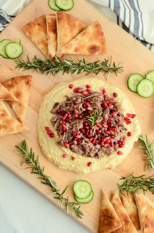 A Loaded Mediterranean Hummus Board with Pulled Lamb can serve as a healthy appetizer to feed a crowd or a light dinner for you and your family.