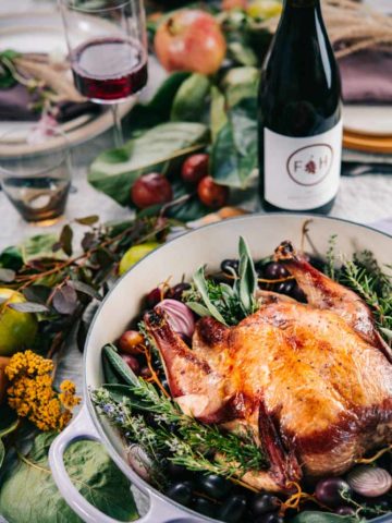 This Red Wine Roast Chicken with Grapes and Herbs is an easy, showstopper entree for fall dinners or holiday entertaining.