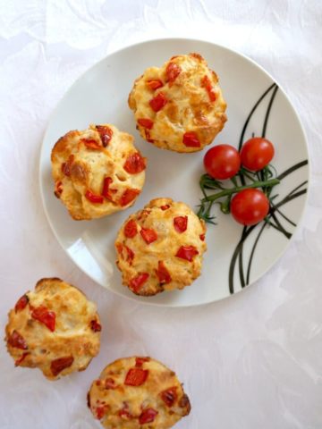 A plate of Savoury Breakfast Muffins adorned with cherry tomatoes.