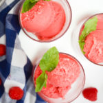 An overhead shot of three glasses filled with Three-Ingredient Raspberry Meyer Lemon Sorbet garnished with fresh mint.