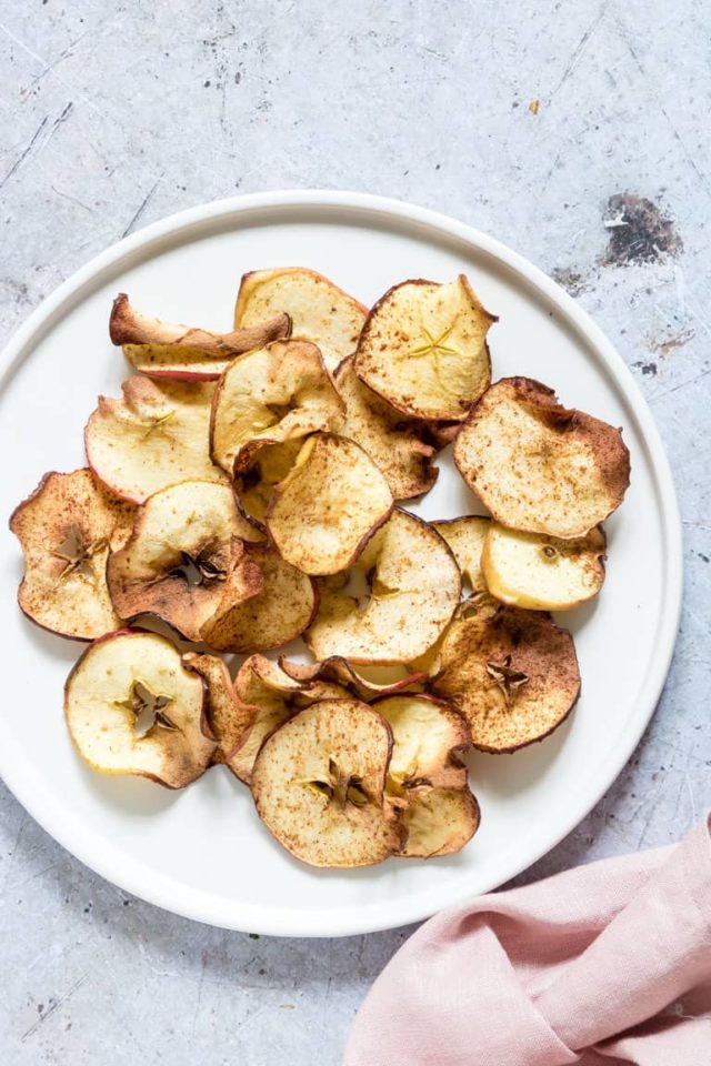 An overhead shot of a plate of Air Fryer Apple Chips - a fun snack for babies and toddlers!