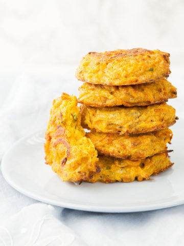A stack of Butternut Squash Fritters on a plate. The perfect baby- and toddler-friendly snack!