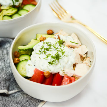 A Mediterranean Bowl loaded with chicken, tomatoes, cucumber and tzatziki.