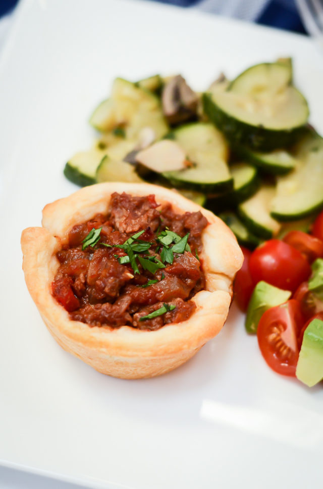 A "Not-So-Sloppy" Joe on a kids' plate with zucchini and tomato salad.