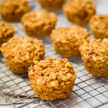 A cooling rack of freshly baked Pumpkin Apple Oatmeal Cups.