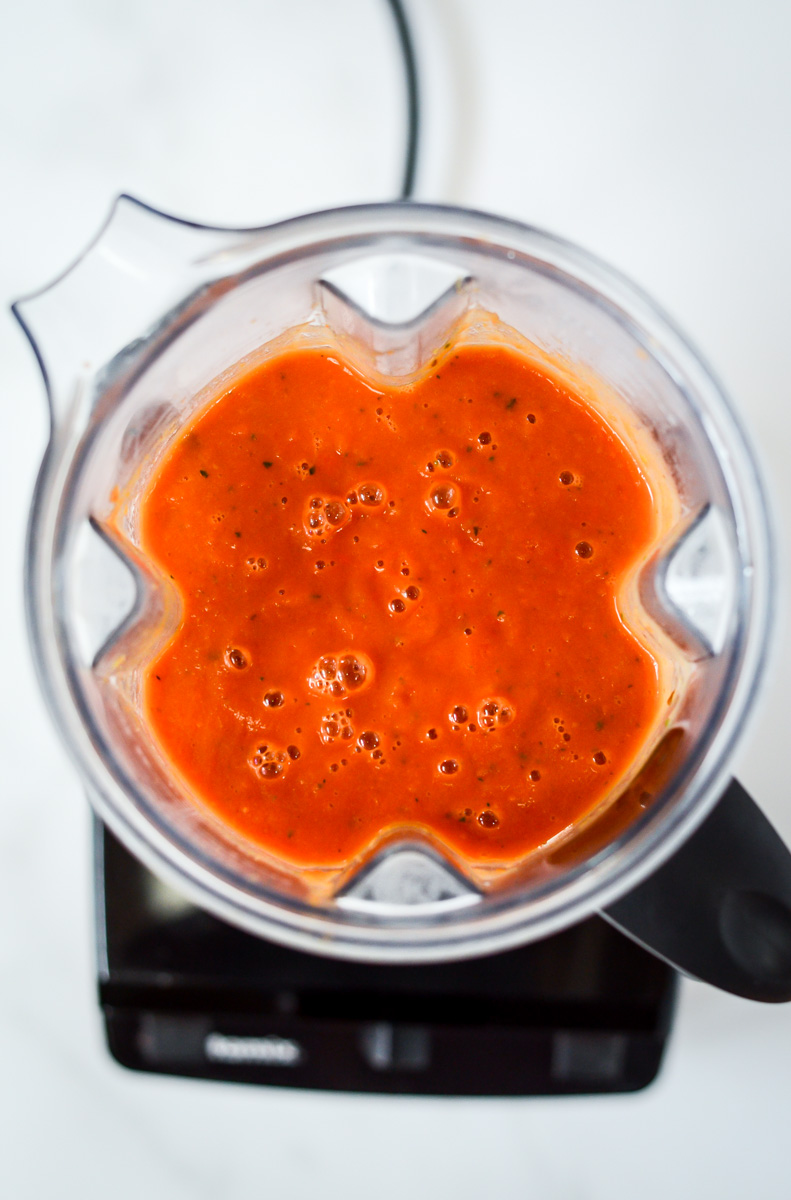 An overhead shot of pureed pasta sauce in a blender.
