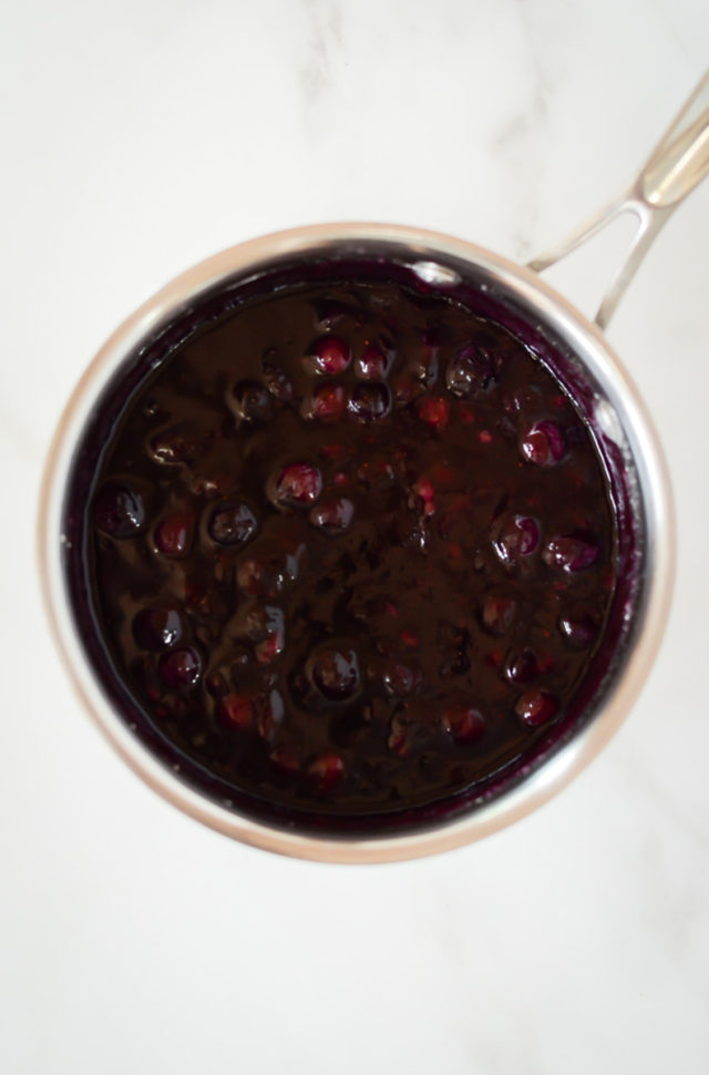 A saucepan of blueberry compote.