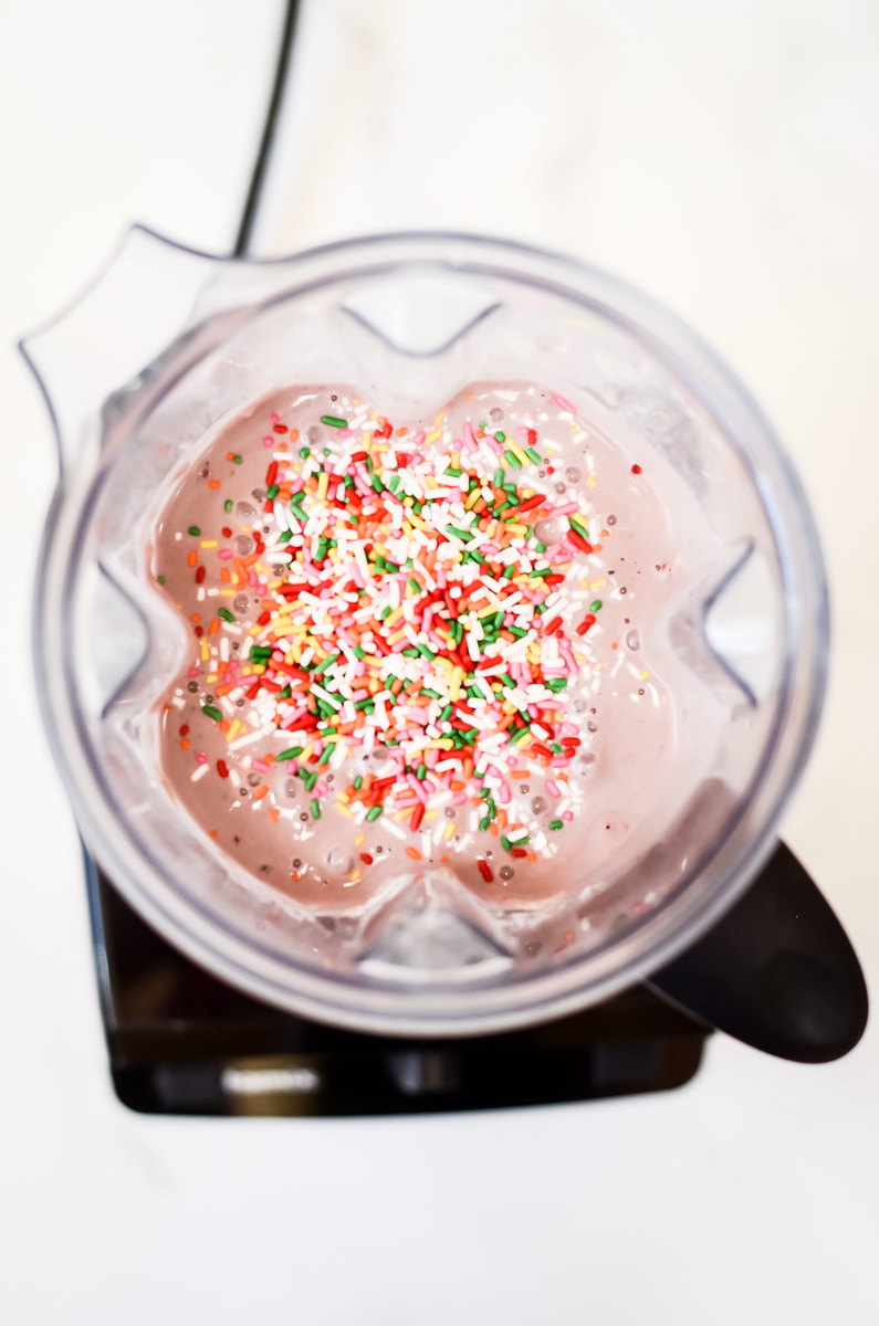 An overhead shot of blended waffle batter with sprinkles.