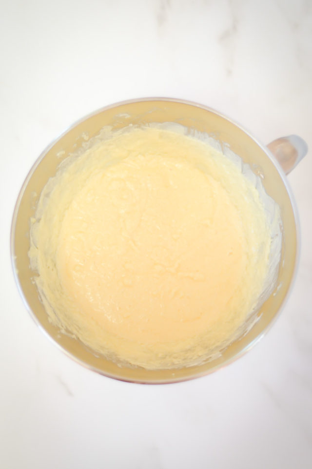 The butter and sugar mixture for vanilla cake in a mixing bowl.,