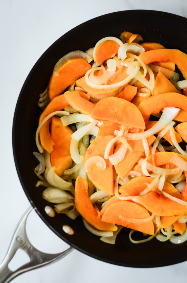 Butternut squash and onion in a sauté pan.