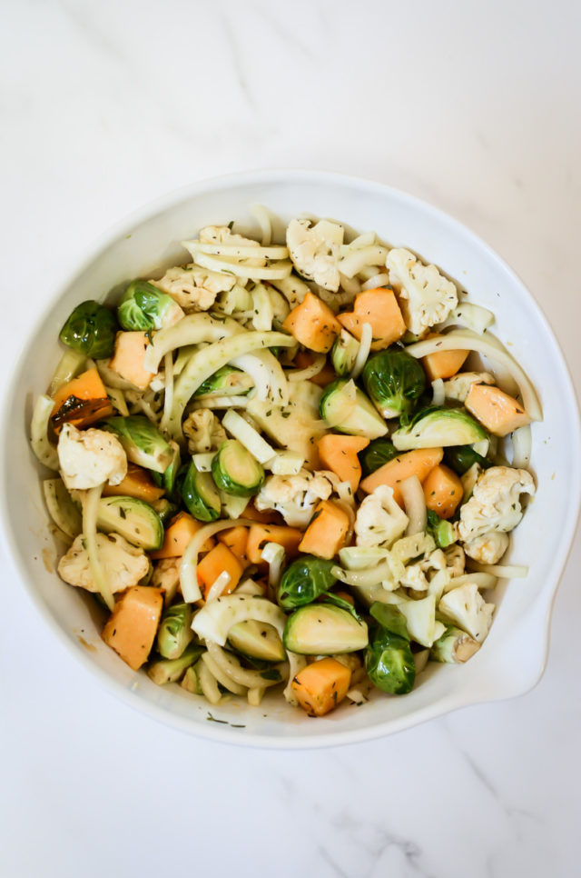 A bowl of chopped vegetables tossed in maple dressing.