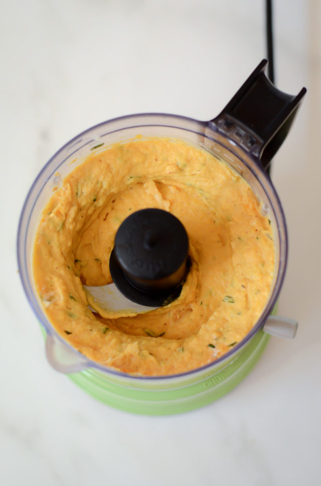 A food processor filled with butternut squash goat cheese spread.