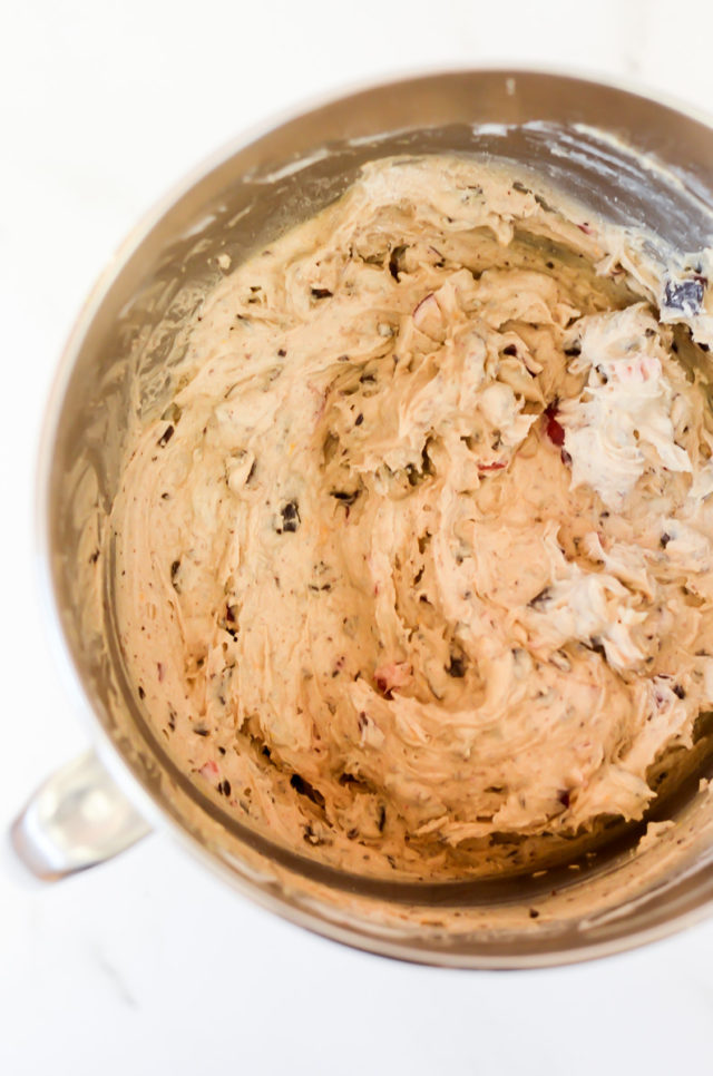 A mixing bowl of cranberry chocolate chunk muffin batter.