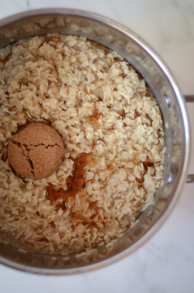 An overhead shot of a saucepan full of oatmeal, maple and brown sugar.