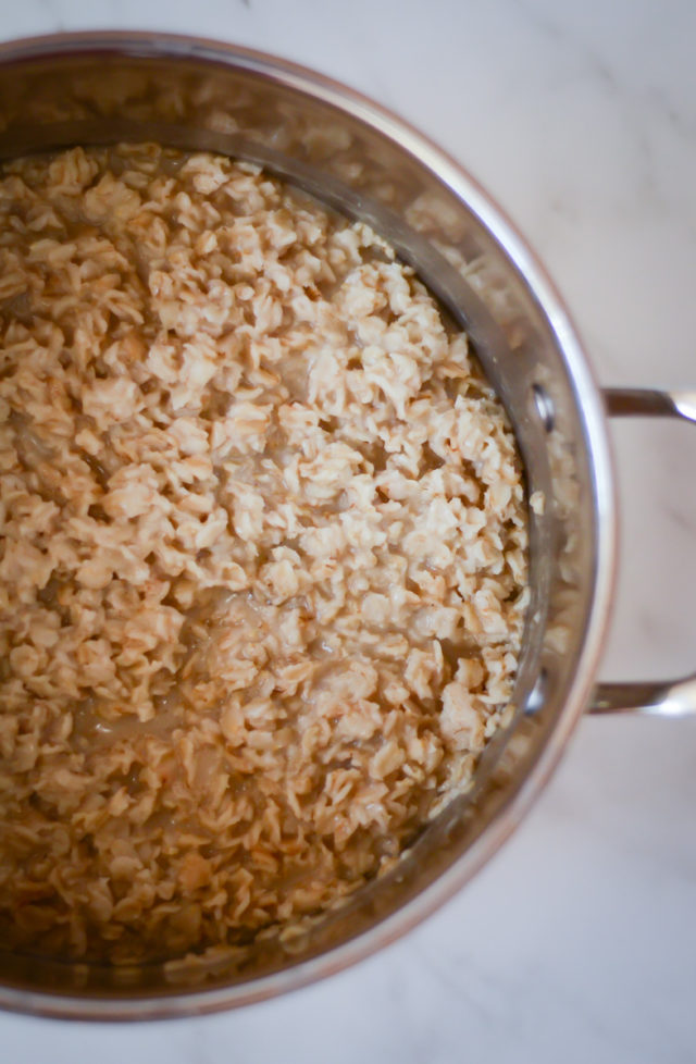 An overhead shot of a saucepan full of oatmeal.