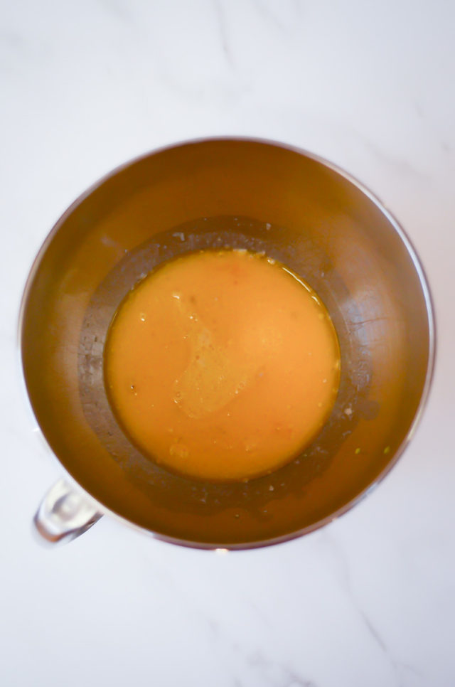 An overhead shot of a mixing bowl with the beginnings of hot cross bun dough.